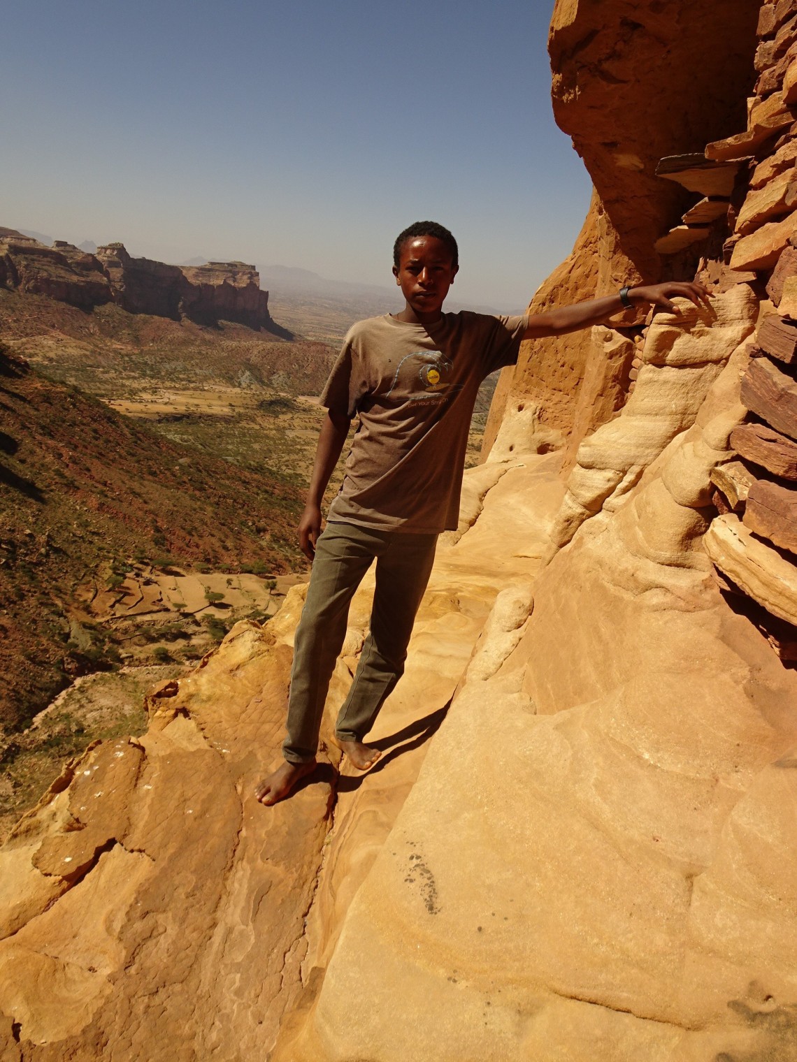 Tsegay on ledge of Abuna Yematha Guh